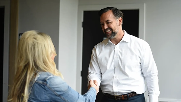 Chiropractor Ankeny IA Aaron Martin Greeting Patient